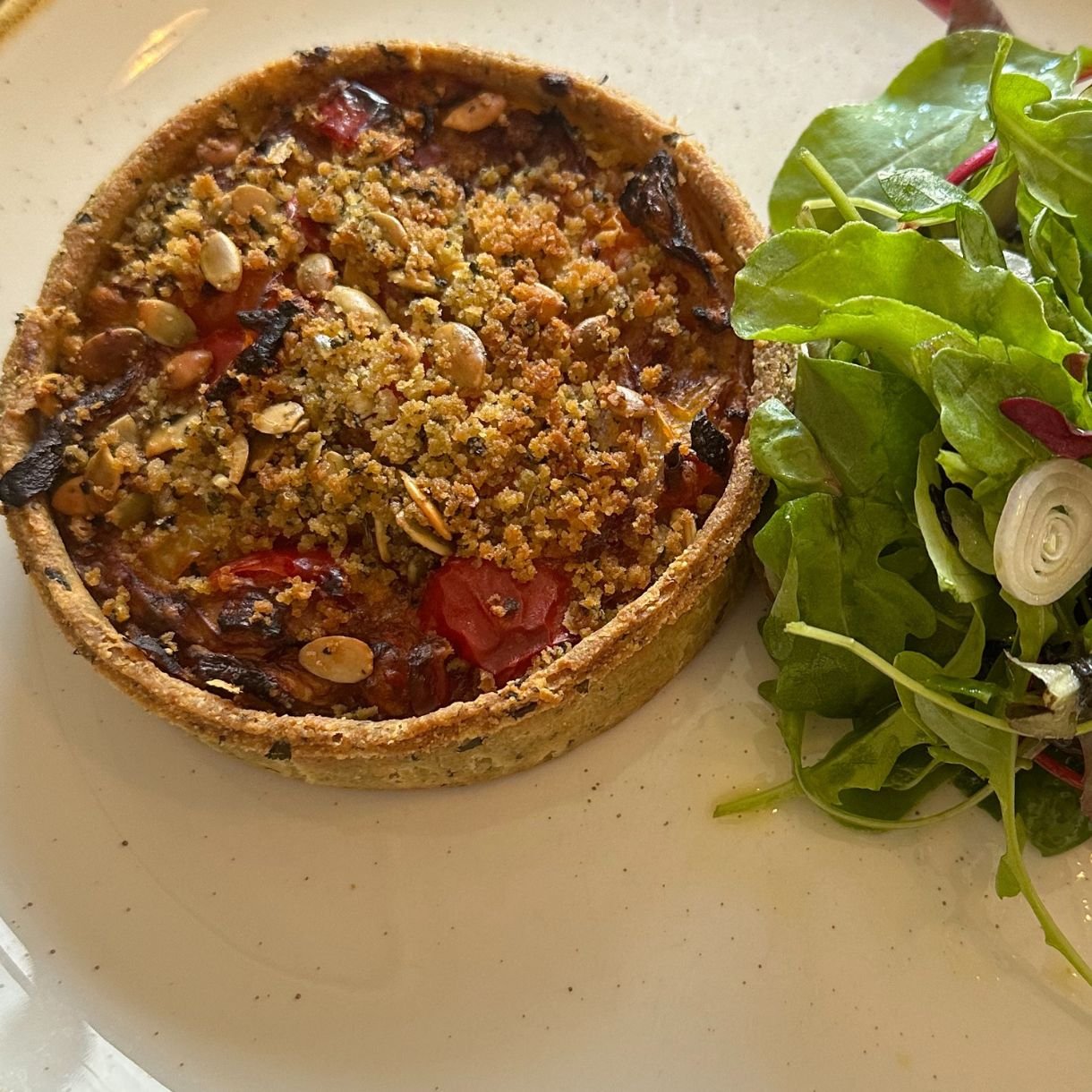 Vegetarian tart with salad garnish