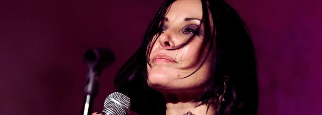 Jo Harrop in profile holding microphone