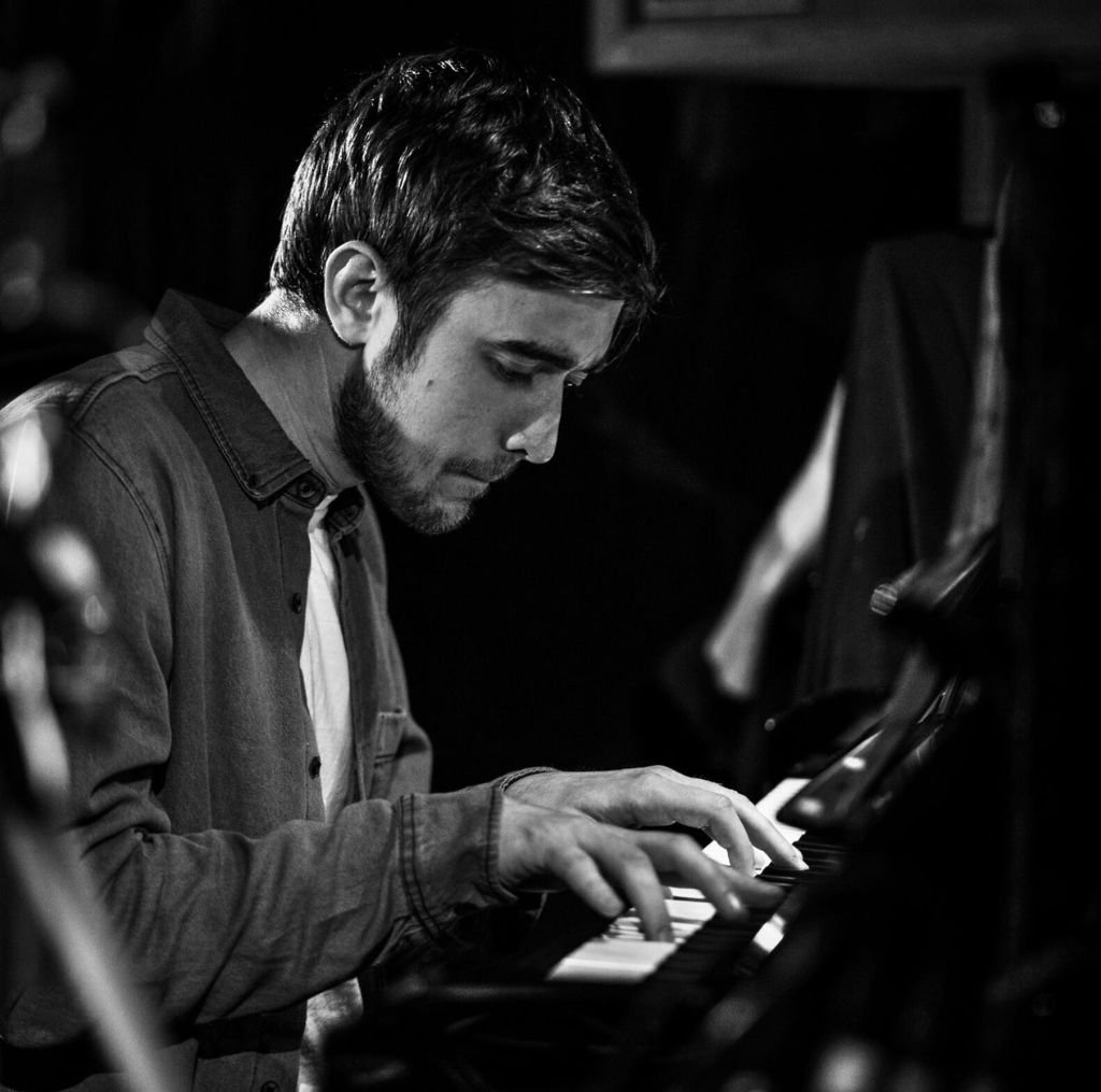 Man in profile playing piano b/w